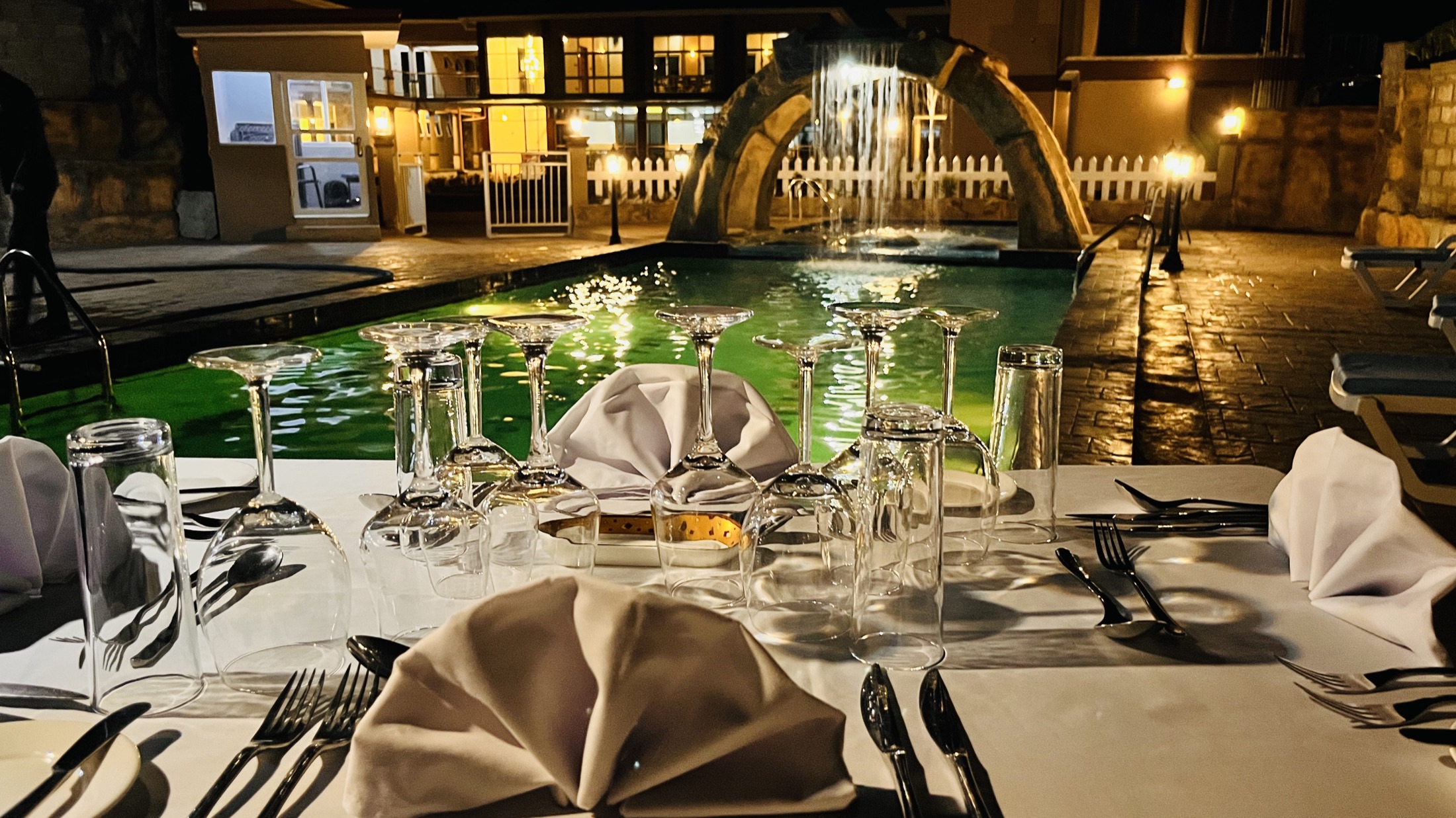 Poolside dining setup at night