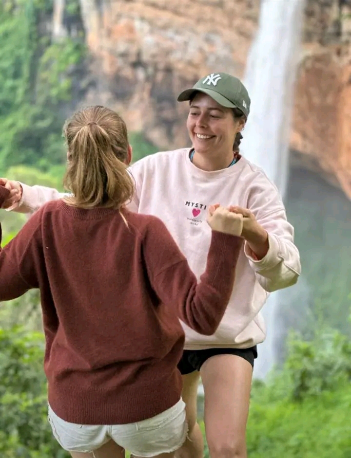 Safari guide standing by a tour jeep in Fort Portal region